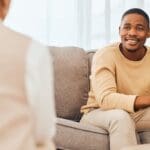 A patient and a psychiatrist who may be discussing an accelerated TMS protocol