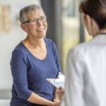 Pharmacogenetic testing for depression represented by a medical provider explaining something to a patient.