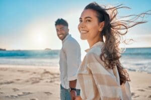 Shot of a young couple spending time together at the beach, demonstrating how ketamine can improve quality of life for people with Depression